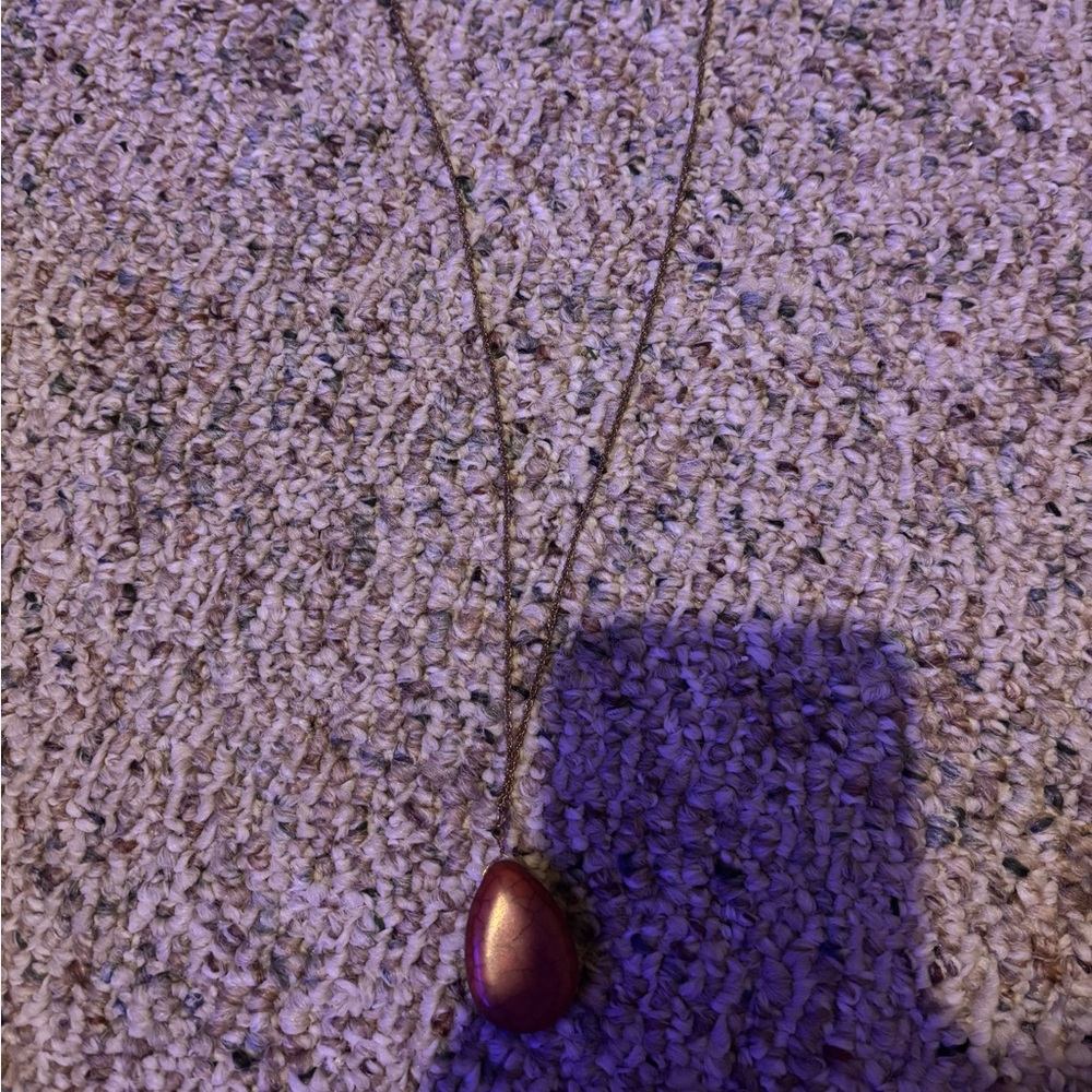 Gold necklace with red rock